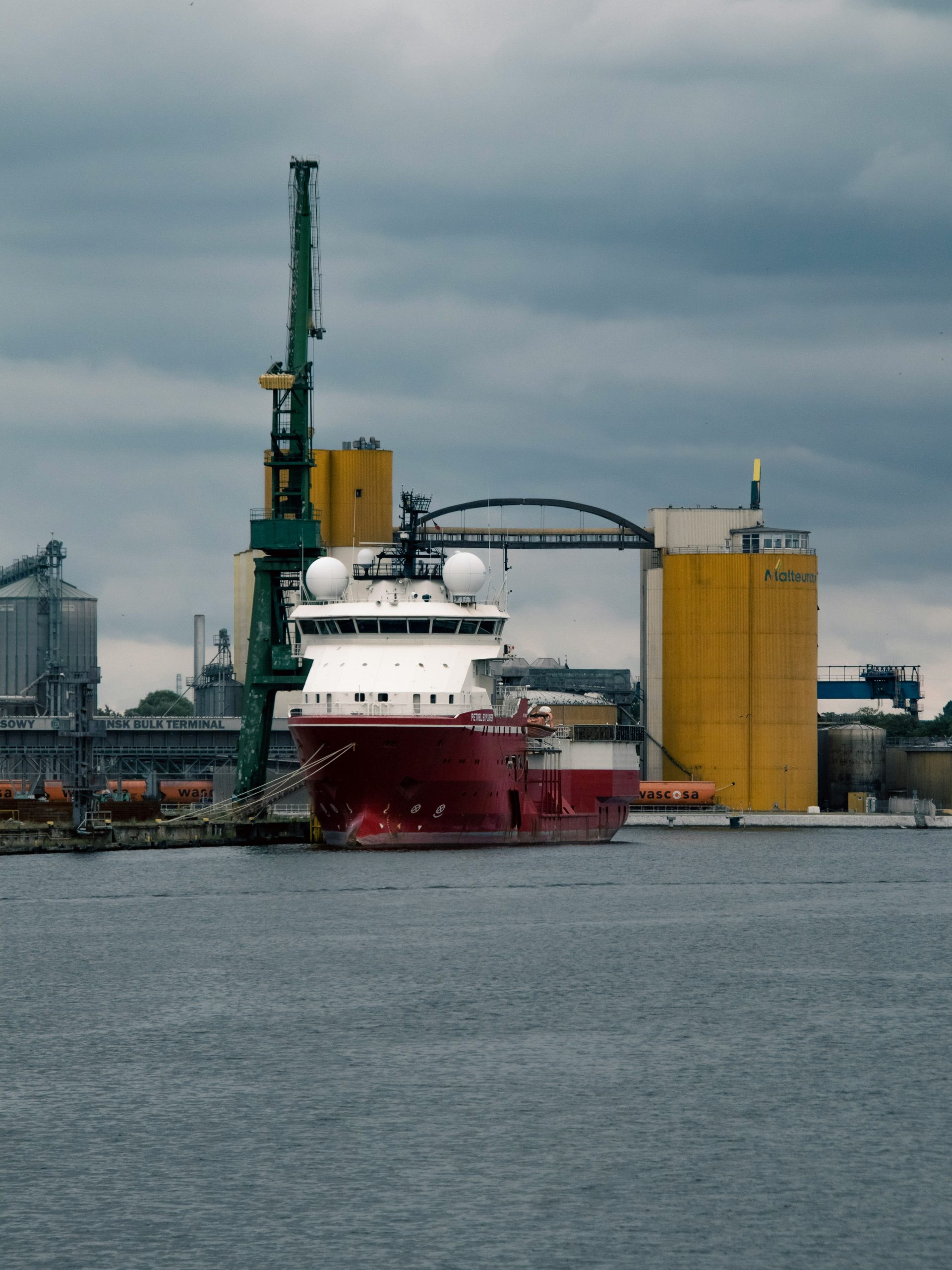 Man Using Measuring Tape in Factory Setting Man Using Measuring Tape in Factory Setting
